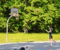 playing basketball in outdoor basketball court or playground in city park