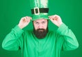 May the luck of the irish be with you. Irish man with beard wearing green. Hipster in leprechaun costume touching hat Royalty Free Stock Photo