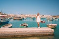 Beautiful view on the traditional eyed colorful boats Luzzu in the Harbor of Mediterranean fishing village Marsaxlokk, Malta Royalty Free Stock Photo