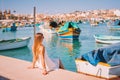 Beautiful view on the traditional eyed colorful boats Luzzu in the Harbor of Mediterranean fishing village Marsaxlokk, Malta Royalty Free Stock Photo