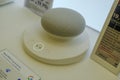 May 2022 Milan, Italy: Google Nest Mini close-up in the electronics store. Google Nest Mini logo icon