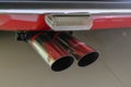 May 2022 Modena, Italy: Chrome plated exhaust pipe close-up of the Ferrari sportscar car. Ferrari logo icon Royalty Free Stock Photo