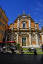 May 2022 Modena, Italy: Church of San Giorgio and people in cafe in the street on a sunny day