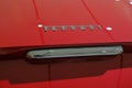 May 2022 Modena, Italy: Ferrari logo icon close-up on red car. details of the sportscar