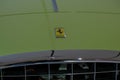 May 2022 Modena, Italy: Green retro Ferrari car with Ferrari company logo icon close-up across the chrome lattice