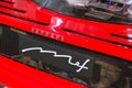 May 2022 Modena, Italy: Red Ferrari sportscar back part with spoiler, headlights and Ferrari logo icon close-up