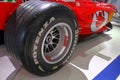 May 2022 Modena, Italy: Red retro Ferrari race car, its cabin, and wheel close-up in the Ferrari Museum. Ferrari logo icon