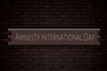 May month, day of May. Amnesty International Day, on Bricks Background