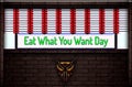 May month special day. Eat What You Want Day, Neon Text Effect on Bricks Background Royalty Free Stock Photo