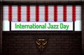 May month special day. International Jazz Day, Neon Text Effect on Bricks Background