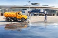 Airfield service workers cleaning the airport apron truck