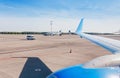 View of the runway and aircraft on the taxiway from the airplaine window