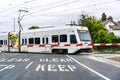 May 9, 2019 Mountain View / CA / USA - Waiting at a barrier for a VTA Train to pass in south San Francisco bay; VTA Light Rail is