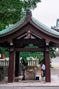 Japanese family wash their hand at Temizuya Holy water pavilion