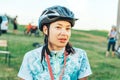 May 26-27, 2018 Naliboki, Belarus Portrait of a woman smiling and enjoying nature outdoors riding bike . Headshot of