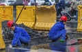 Workers who repair underground pipes in the rain