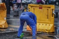 Workers who repair underground pipes in the rain