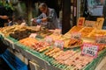 Seller cooking with blowtorchs fresh seafood in a Osaka market, Japan.