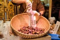 Seller serving roasted chestnuts in a paper bag at Osaka market in Japan. Royalty Free Stock Photo