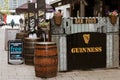 a typical Irish bar on the streets of Cork with Guinness signs and wood barrels outside