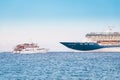 Big cruise ship liner and small ferry boat meet together in open sea - vacation and transport concept Royalty Free Stock Photo