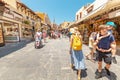 Crowds of tourists walking and shopping at market street in Rhodos town, leading to famous Mosque