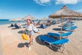 People resting on a beach with umbrellas and sunbeds Royalty Free Stock Photo