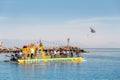 Tourist ferry Yellow Submarine with travelers on Board runs along the route with a parachutist in the