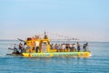 Tourist ferry Yellow Submarine with travelers on Board runs along the route with a parachutist in the