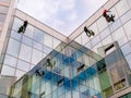 May 12, 2021, Russia, Moscow. Industrial climbers wash the windows of a high-rise glass building.