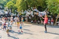 street artist makes a soap bubble show for children to receive donations from their parents