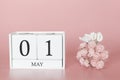 May 01st. Day 1 of month. Calendar cube on modern pink background, concept of bussines and an importent event