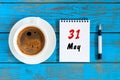 May 31st. Day 31 of month, tear-off calendar with morning coffee cup at work place background. Spring time, Top view