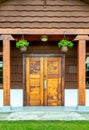 May 26, 2019 - Surrey, BC: Carved wood doors, picnic shelter at Peace Arch Park.