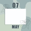 May 07. 07th day of the month, calendar date. Clean white sheet on an abstract gray-green background with an outline of iris