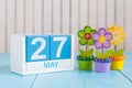 May 27th. Image of may 27 wooden color calendar on white background with flowers. Spring day, empty space for text Royalty Free Stock Photo