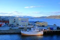 May 28 2022 - Tromso, Norway: Ships approach the port, Snowy mountains in the background Royalty Free Stock Photo