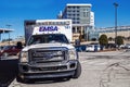 May 7, 2023, Tulsa OK Ford Emsa Ambulance parked in lot across from hospital with cross on sunny day