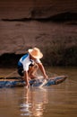 Local Thai fisherman and fishing net on boat in Mekong river Royalty Free Stock Photo