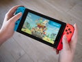 May 2020, UK: Nintendo switch new Moving Out game handheld console Royalty Free Stock Photo