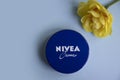 May 1, 2022 Ukraine city Kyiv jar of Nivea clean product cream, narcissus flower a colored background