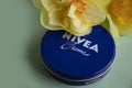 May 1, 2022 Ukraine city Kyiv jar of Nivea design product cream, narcissus flower a colored background