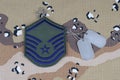 May 12, 2018. US AIR FORCE Master Sergeant rank patch and dog tags on desert camouflage uniform background Royalty Free Stock Photo