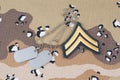 May 12, 2018. US ARMY Corporal rank patch and dog tags on Desert Battle Dress Uniform background