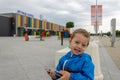 May 24, 2019 in Varna, Bulgaria Little boy sitting on stone bench in front of Terminal 2 at the Varna International Airport