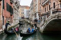 People enjoying gondola rides on canal in Venice