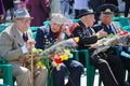 May 9. Victory Day. Older men, veterans of the war, sitting with medals and flowers