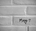 ` May 9 ` WRITTEN ON WHITE PLAIN BRICK WALL