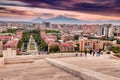 Scenic view from the stairs of Cascade monument to the colorful sunset over roofs of Yerevan city