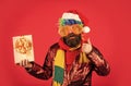 May your Christmas be filled with joyful noise. merry christmas. man with beard on red background. brutal bearded man in Royalty Free Stock Photo